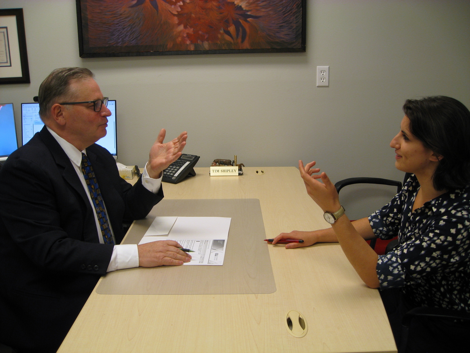Tim Shipley and a mock customer discussing estate planning and review