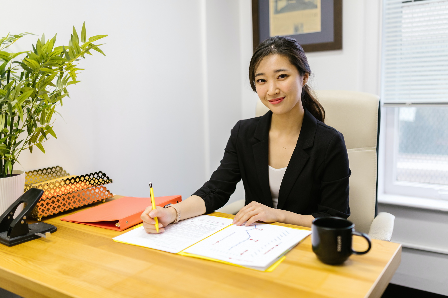 Women at a desk signing a document