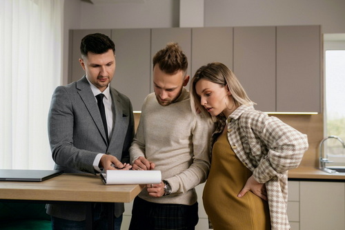 People signing documents for their new house